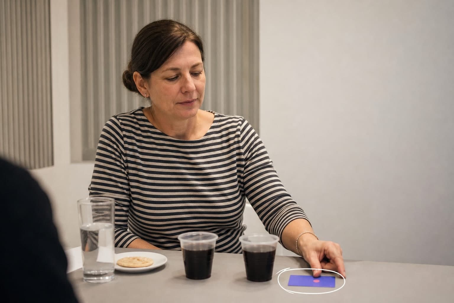 A participant choosing between two blind-coded samples in a preference test.