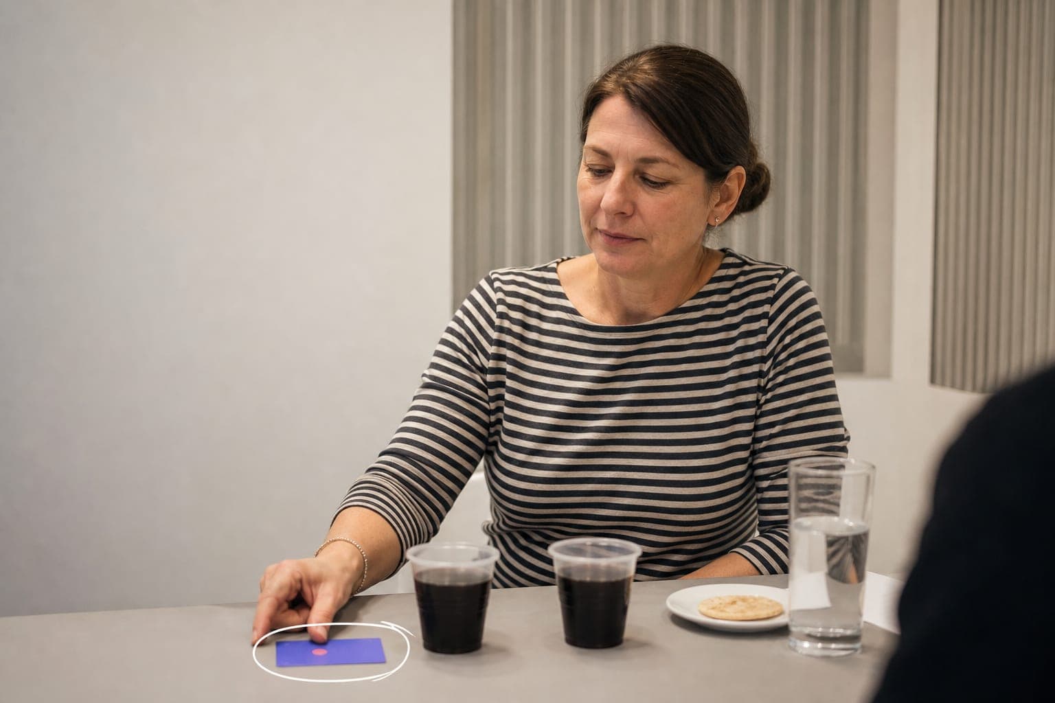A participant choosing between two blind-coded samples in a preference test.